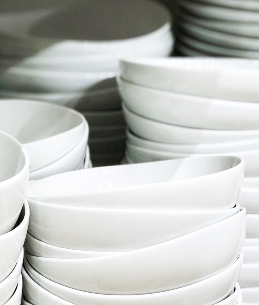Stacks of glass-based, sustainable tableware for in-flight dining.